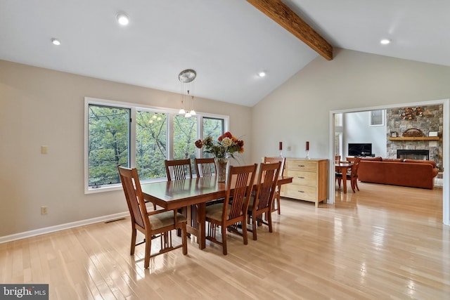dining area with recessed lighting, lofted ceiling with beams, light wood-type flooring, a fireplace, and visible vents