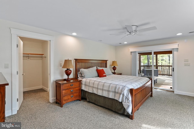bedroom with light colored carpet, a spacious closet, recessed lighting, and access to exterior
