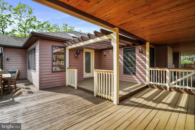 wooden deck featuring outdoor dining area