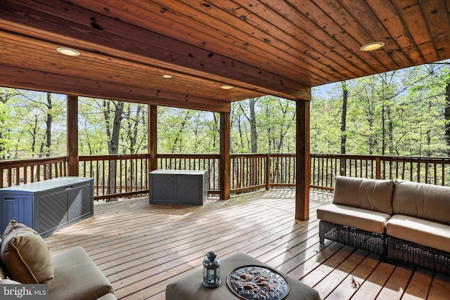wooden terrace with an outdoor living space
