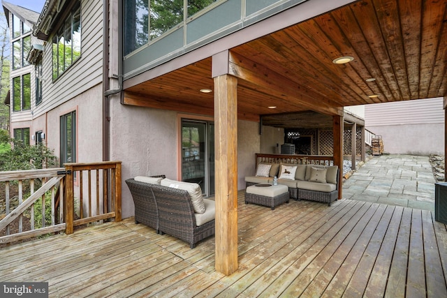 wooden deck with an outdoor living space