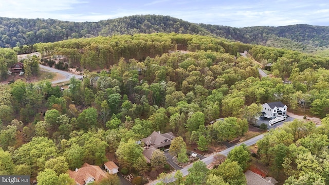drone / aerial view featuring a wooded view