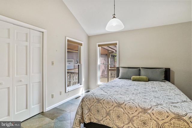 tiled bedroom with visible vents, vaulted ceiling, and baseboards