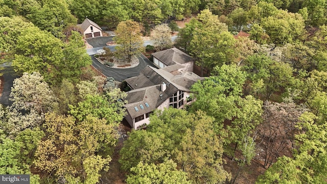 drone / aerial view featuring a forest view