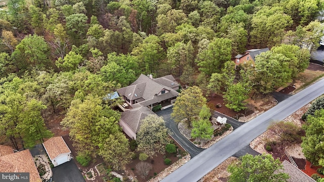 birds eye view of property with a wooded view