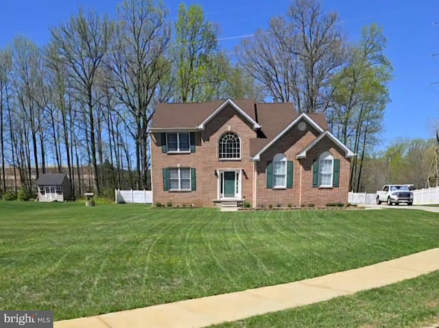 311 Patsy Ct, West Deptford, NJ 08066 - view of front facade featuring brick siding, a front lawn, and fence