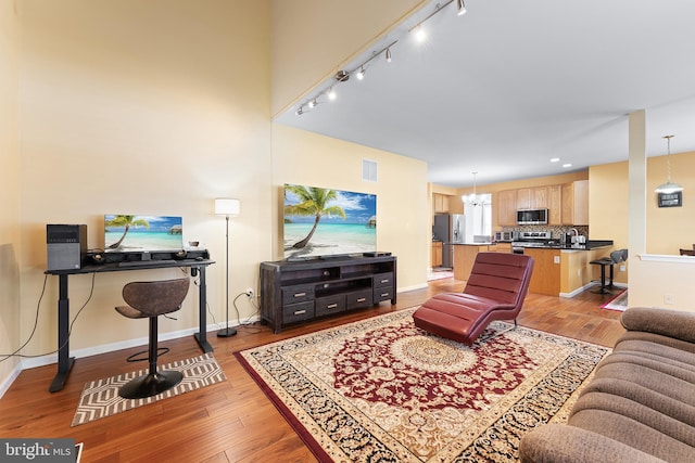 311 Patsy Ct, West Deptford, NJ 08066 - living area featuring track lighting, baseboards, wood finished floors, and visible vents