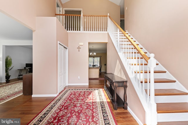 311 Patsy Ct, West Deptford, NJ 08066 - entryway with a towering ceiling, baseboards, a notable chandelier, wood finished floors, and stairs