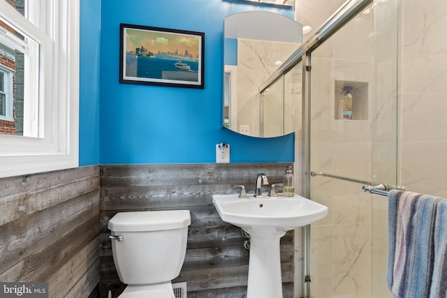 1448 Sheridan St NW, Washington, DC 20011 - full bathroom featuring toilet, a stall shower, and a wainscoted wall