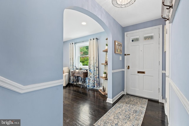 1448 Sheridan St NW, Washington, DC 20011 - foyer entrance with arched walkways, wood finished floors, and baseboards