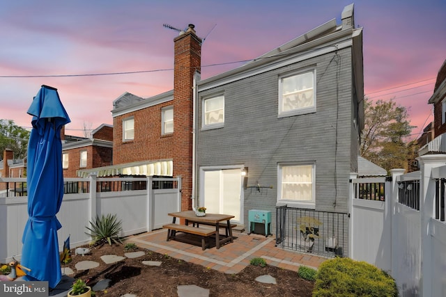 1448 Sheridan St NW, Washington, DC 20011 - back of house featuring a patio area, a chimney, and brick siding