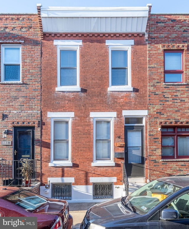 view of property with brick siding