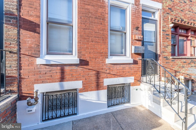 doorway to property with brick siding