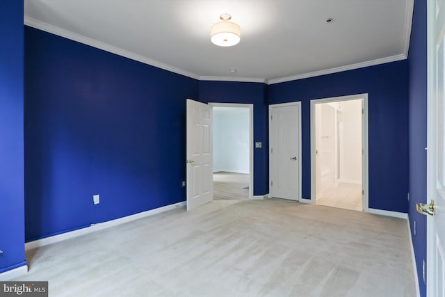 unfurnished bedroom with carpet flooring, crown molding, connected bathroom, and baseboards