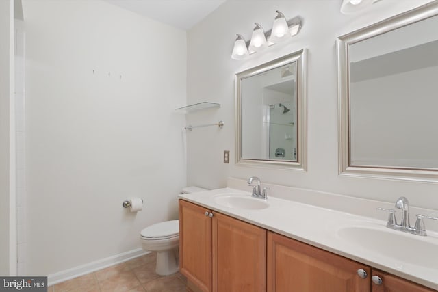 full bathroom featuring tile patterned floors, double vanity, toilet, and a sink