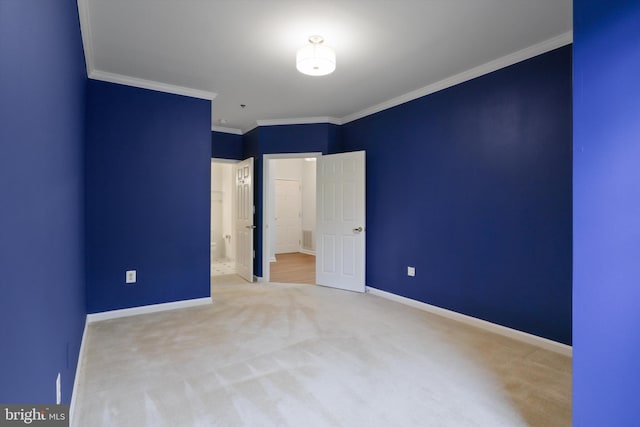 unfurnished bedroom with crown molding, baseboards, and carpet