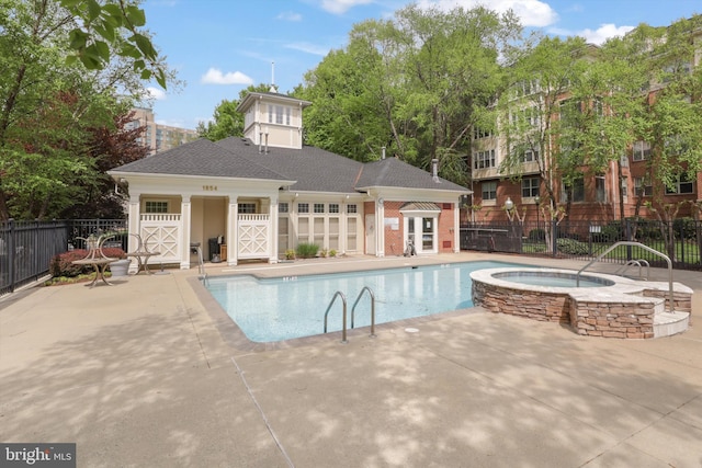 community pool with fence, a patio, and a community hot tub