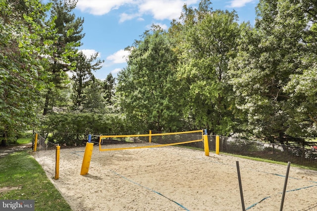 surrounding community featuring fence and volleyball court