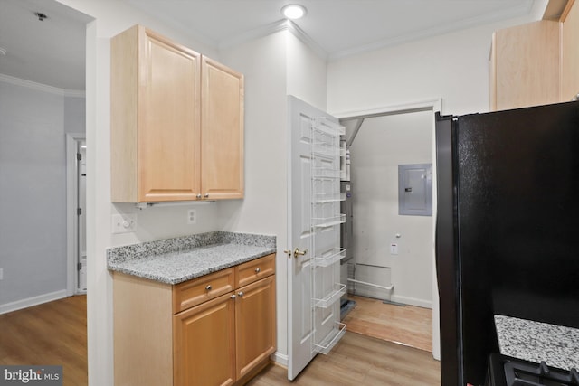 kitchen featuring freestanding refrigerator, light wood-type flooring, light brown cabinets, and ornamental molding