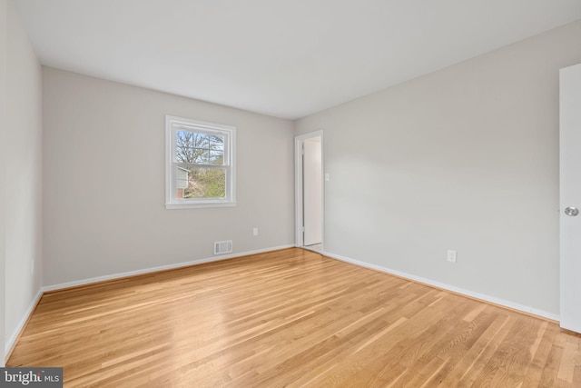 unfurnished room with visible vents, baseboards, and light wood-style floors