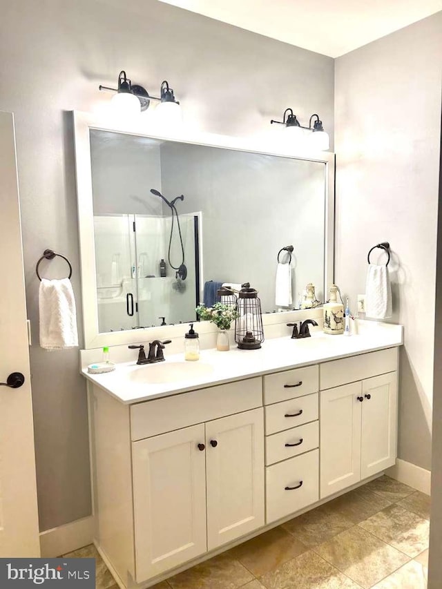 1605 Quincey Dr, Mechanicsburg, PA 17050 - bathroom with a shower stall, double vanity, a sink, and baseboards