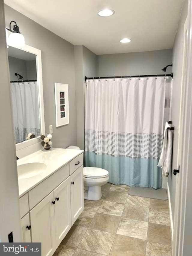 1605 Quincey Dr, Mechanicsburg, PA 17050 - bathroom featuring toilet, vanity, stone finish flooring, and recessed lighting