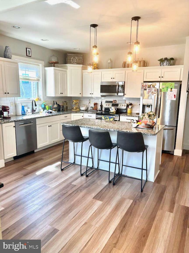 1605 Quincey Dr, Mechanicsburg, PA 17050 - kitchen with light wood finished floors, appliances with stainless steel finishes, decorative backsplash, and white cabinets