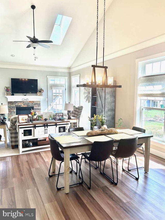 1605 Quincey Dr, Mechanicsburg, PA 17050 - dining area featuring high vaulted ceiling, a fireplace, ornamental molding, and wood finished floors