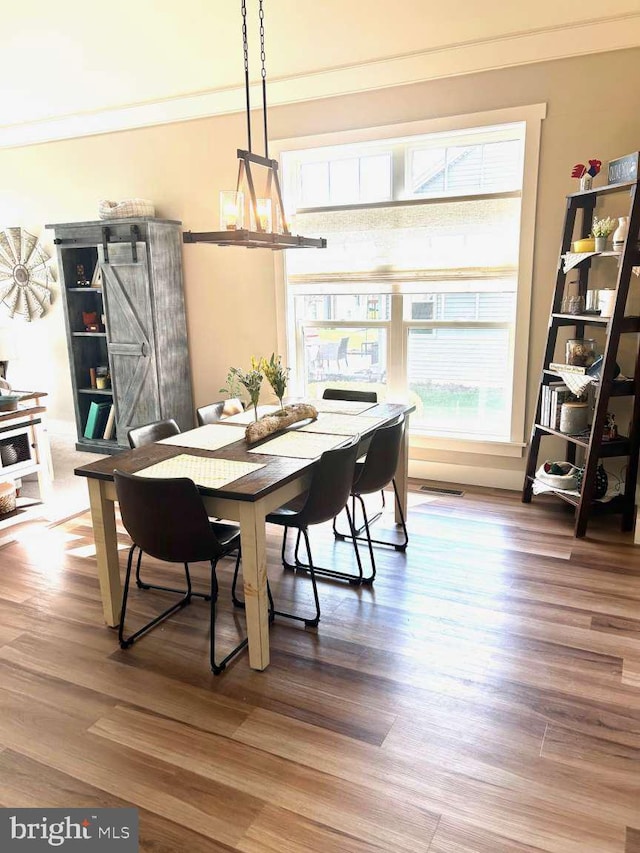 1605 Quincey Dr, Mechanicsburg, PA 17050 - dining room featuring crown molding, light wood finished floors, visible vents, and a barn door
