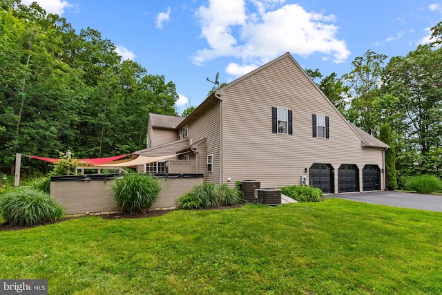 41 Hillview Rd, Morgantown, PA 19543 - view of home's exterior featuring an attached garage, driveway, central air condition unit, and a yard
