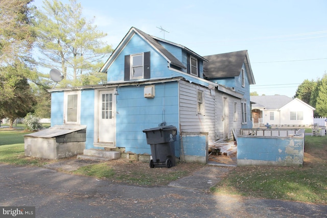 rear view of property with entry steps