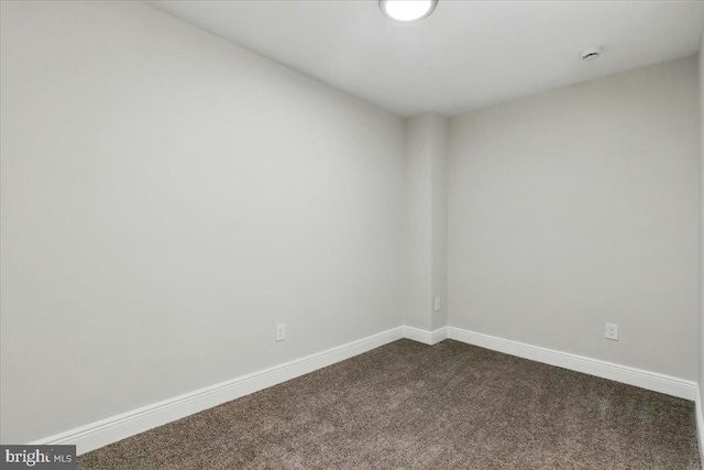605 N Bouldin St, Baltimore, MD 21205 - spare room featuring baseboards and dark carpet