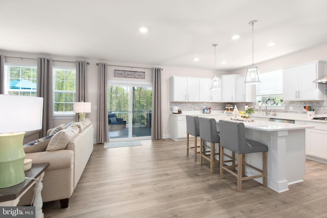 kitchen with a kitchen bar, tasteful backsplash, and a wealth of natural light