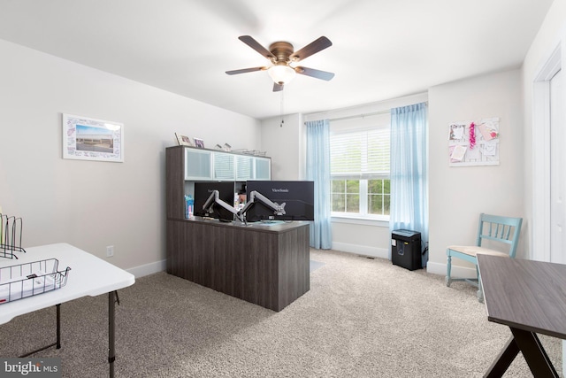office area with ceiling fan, baseboards, and light colored carpet