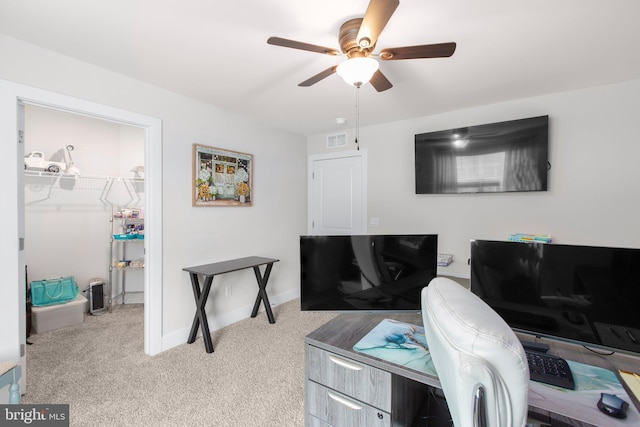 office space with carpet flooring, a ceiling fan, baseboards, and visible vents