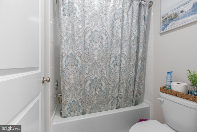 full bathroom featuring shower / bath combination with curtain and toilet