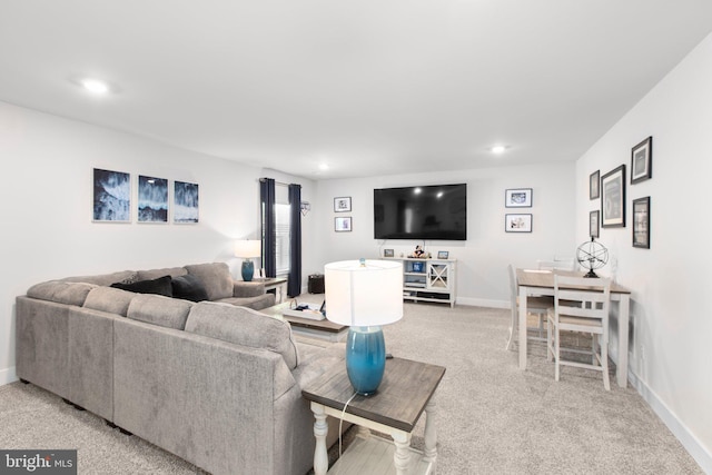living area with baseboards, recessed lighting, and light colored carpet
