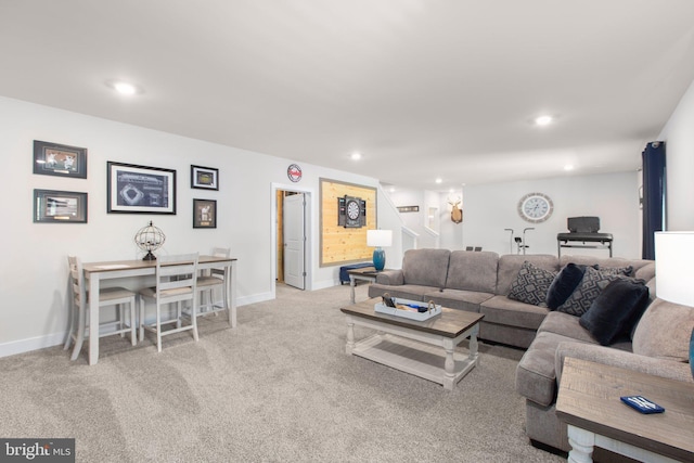 carpeted living area with stairway, baseboards, and recessed lighting