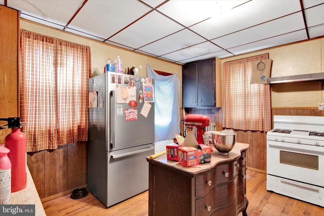 417 N Nichols St, Pottsville, PA 17901 - kitchen featuring light wood-type flooring, a paneled ceiling, freestanding refrigerator, and white range with gas stovetop