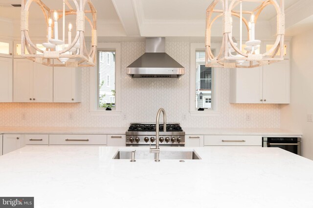 816 Garfield Pkwy, Bethany Beach, DE 19930 - kitchen with wall chimney range hood, a chandelier, crown molding, and healthy amount of natural light