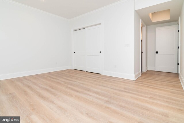 816 Garfield Pkwy, Bethany Beach, DE 19930 - unfurnished bedroom featuring light wood-type flooring, baseboards, ornamental molding, and a closet