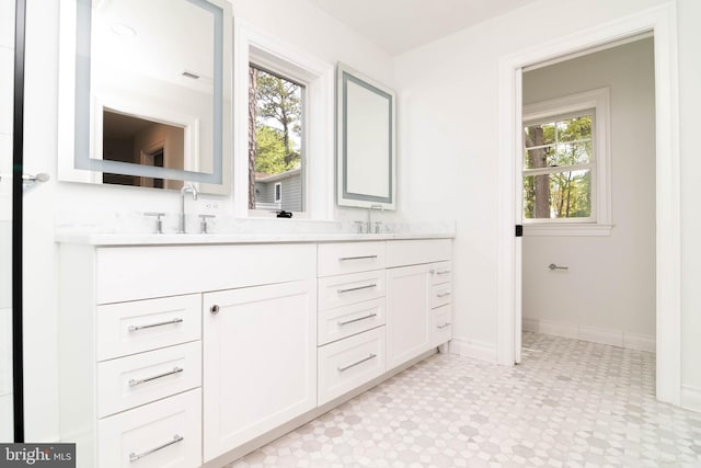 816 Garfield Pkwy, Bethany Beach, DE 19930 - full bathroom with double vanity, plenty of natural light, tile patterned floors, and baseboards