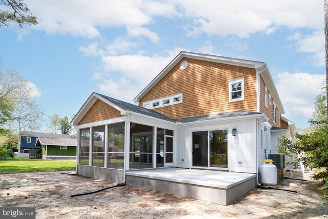 816 Garfield Pkwy, Bethany Beach, DE 19930 - rear view of house featuring a sunroom, a patio, central AC, and board and batten siding