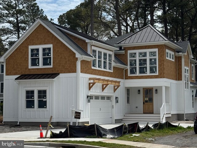 816 Garfield Pkwy, Bethany Beach, DE 19930 - view of front of property featuring a standing seam roof, a garage, board and batten siding, and metal roof