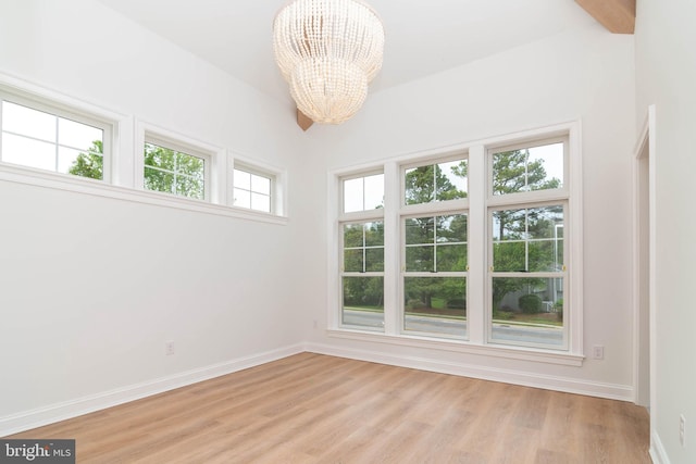 816 Garfield Pkwy, Bethany Beach, DE 19930 - unfurnished room featuring a chandelier, light wood finished floors, and baseboards