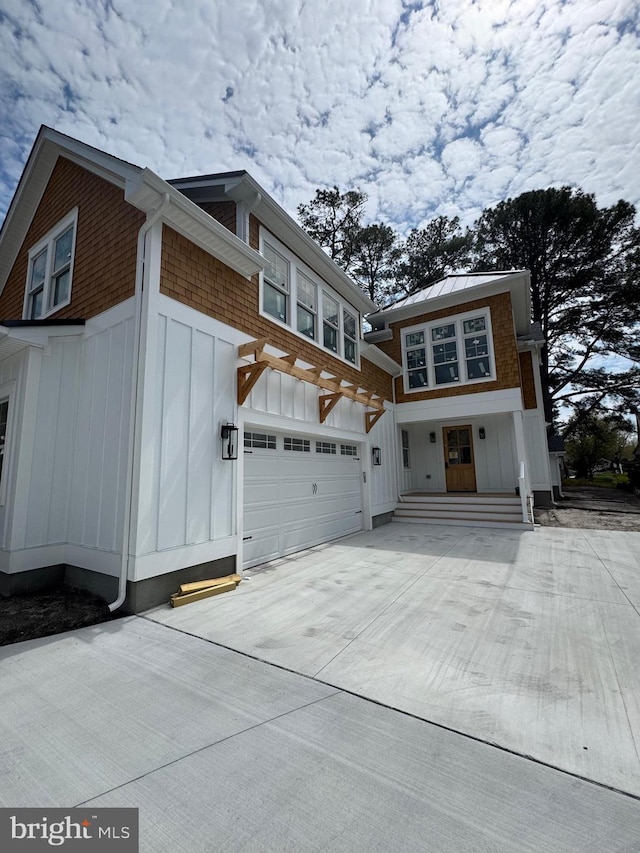 816 Garfield Pkwy, Bethany Beach, DE 19930 - view of side of property with board and batten siding and concrete driveway