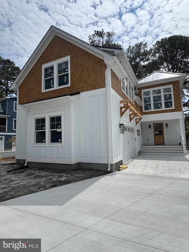 816 Garfield Pkwy, Bethany Beach, DE 19930 - view of side of home featuring board and batten siding, driveway, and a garage