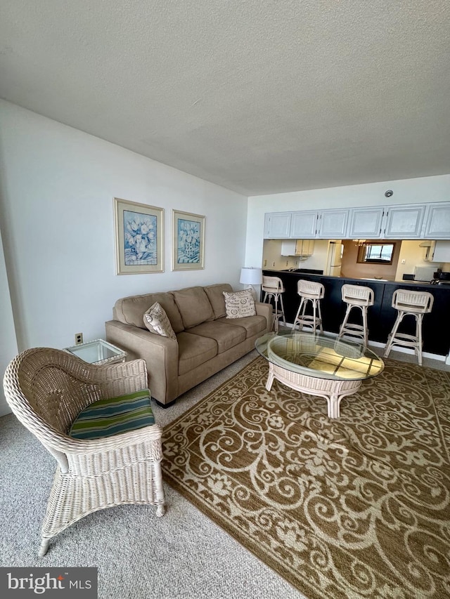 9900 Coastal Hwy Unit 413, Ocean City, MD 21842 - carpeted living room with a textured ceiling
