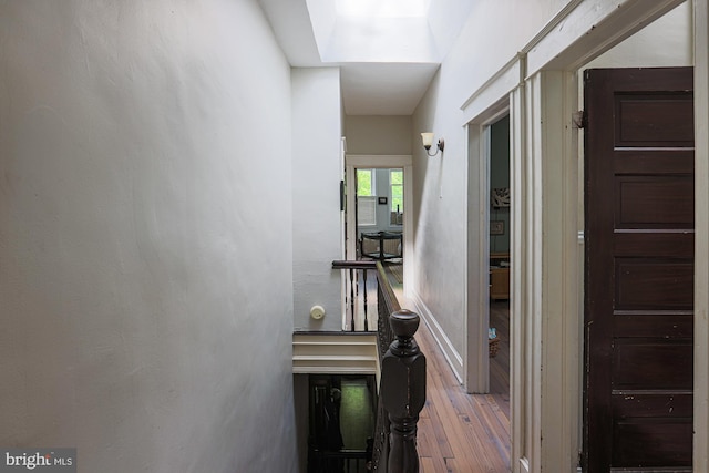 hall with wood finished floors and baseboards