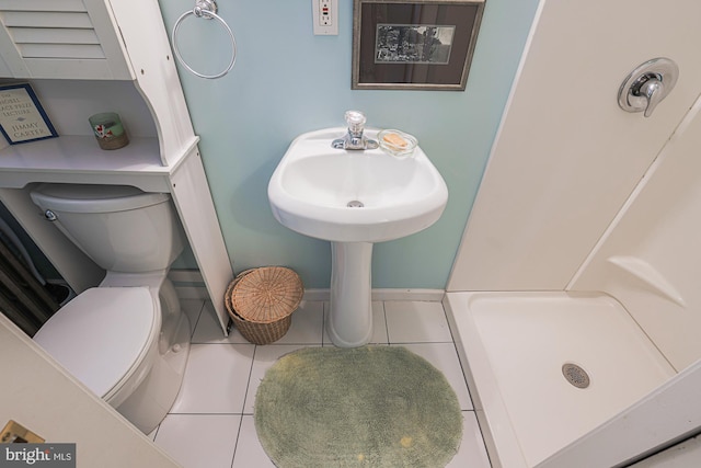 full bathroom featuring a shower stall, toilet, and tile patterned floors
